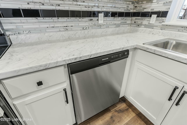 kitchen with decorative backsplash, white cabinetry, dark wood-style flooring, and dishwasher