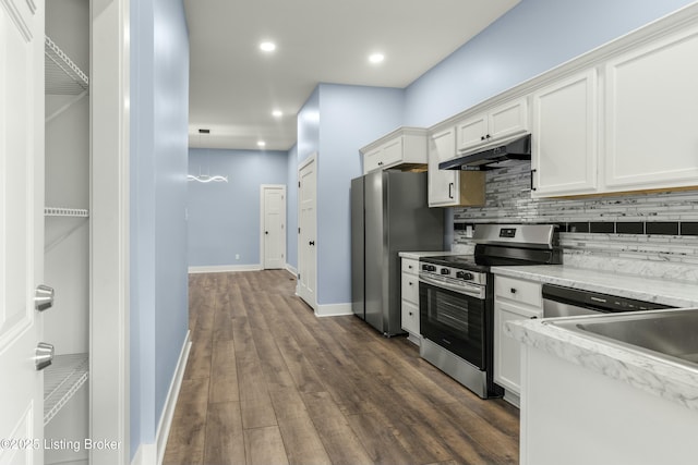 kitchen featuring stainless steel appliances, tasteful backsplash, white cabinets, and under cabinet range hood