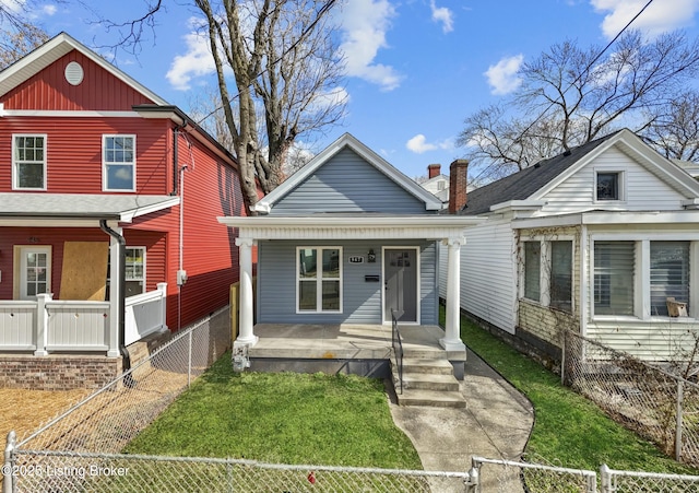 view of front of home with a fenced front yard, a front yard, covered porch, and a gate