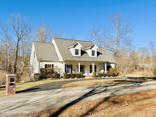 new england style home with covered porch