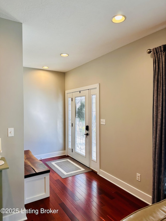 foyer with recessed lighting, dark wood finished floors, and baseboards