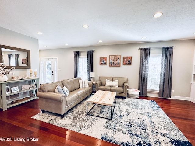 living area with a textured ceiling, baseboards, wood finished floors, and recessed lighting