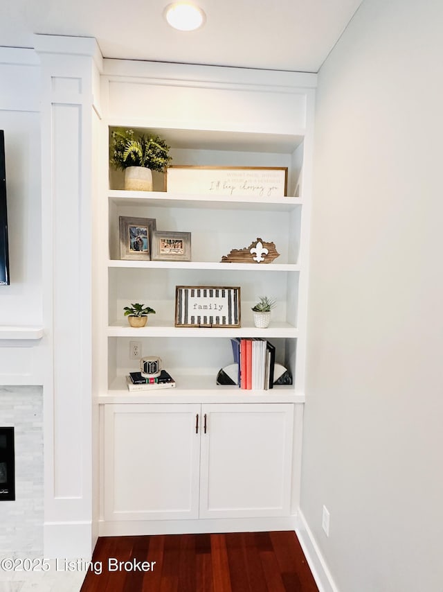 room details with built in shelves, baseboards, and wood finished floors