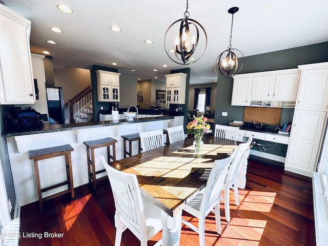 dining area featuring stairs, a chandelier, dark wood-style flooring, and recessed lighting