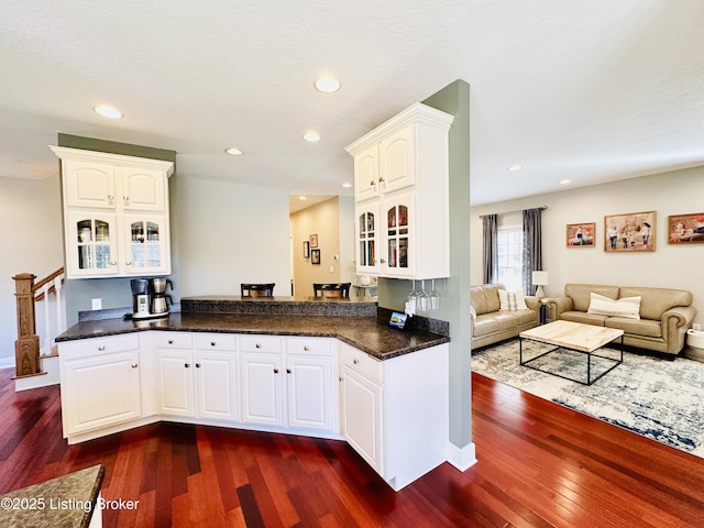 kitchen with glass insert cabinets, recessed lighting, white cabinets, and dark wood-type flooring