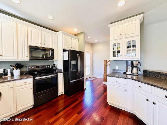 kitchen with electric stove, dark countertops, glass insert cabinets, dark wood-style flooring, and black refrigerator with ice dispenser