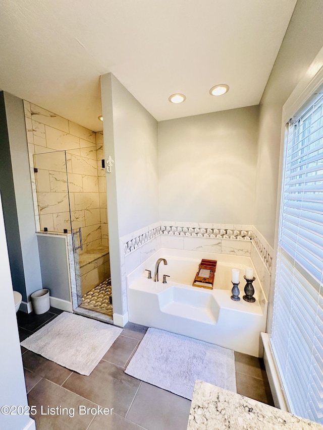 full bath featuring a stall shower, recessed lighting, a bath, and tile patterned floors