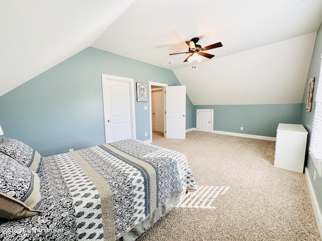 bedroom with a ceiling fan, carpet flooring, vaulted ceiling, and baseboards