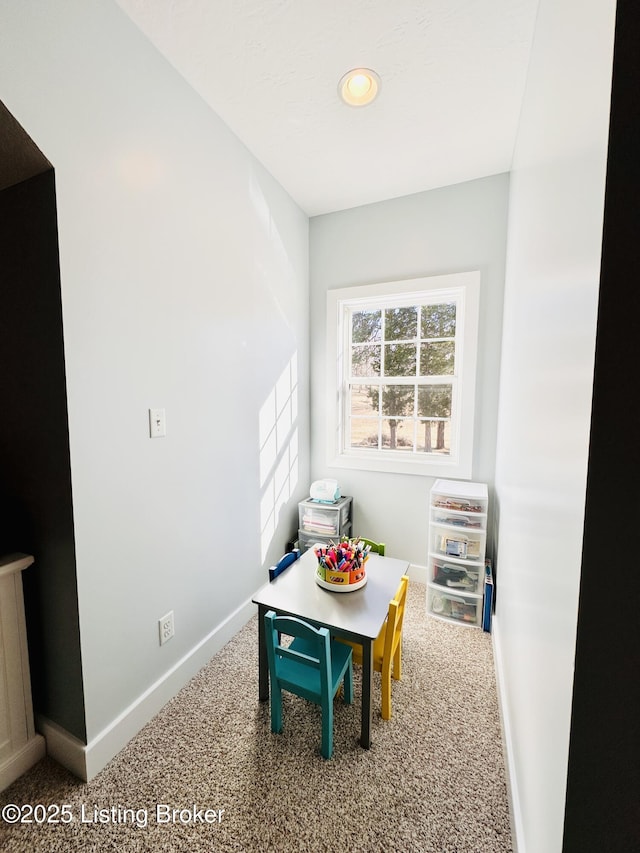 recreation room featuring carpet floors and baseboards