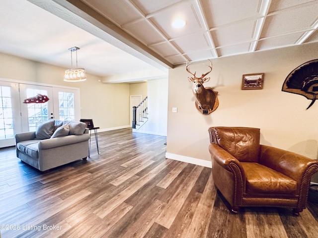 living room with baseboards, stairway, and wood finished floors