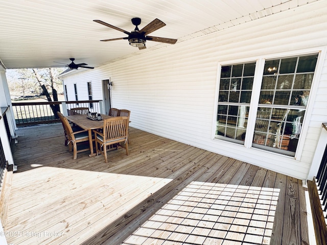 deck featuring a ceiling fan and outdoor dining space