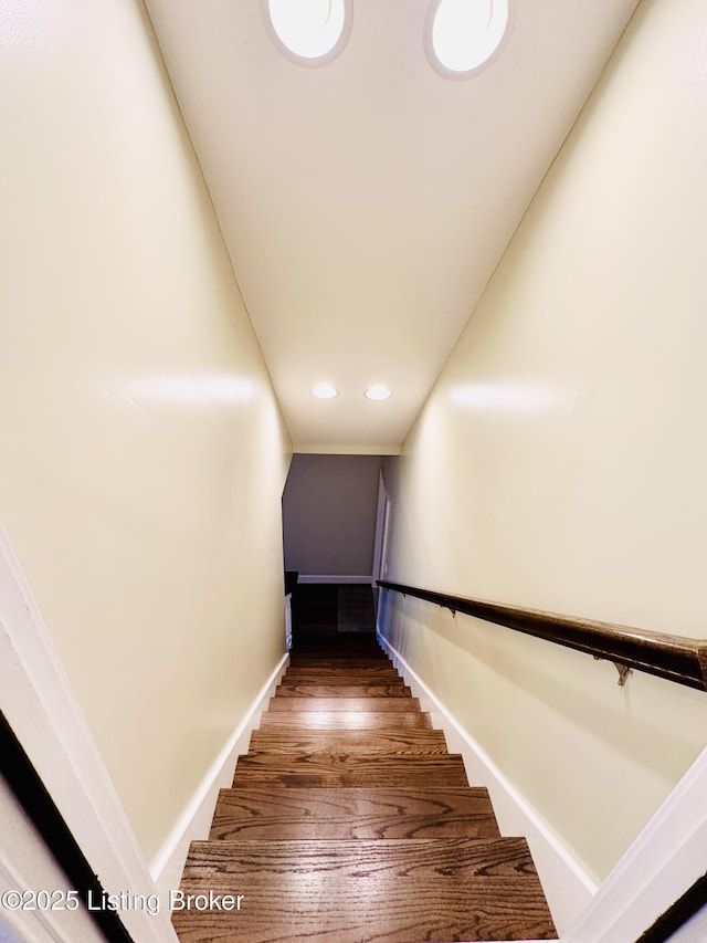 stairs with baseboards, wood finished floors, and recessed lighting