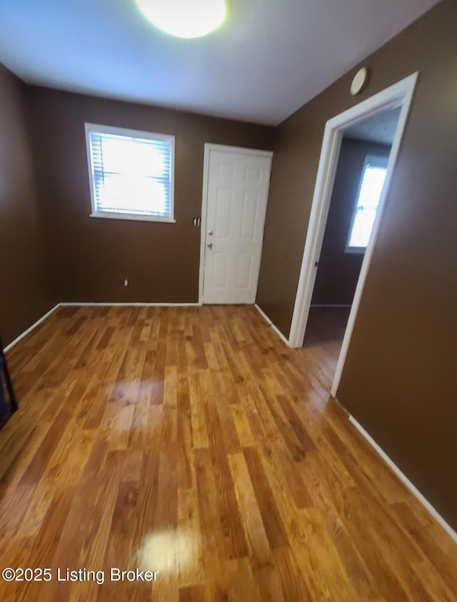 interior space featuring a wealth of natural light, baseboards, and light wood-style floors