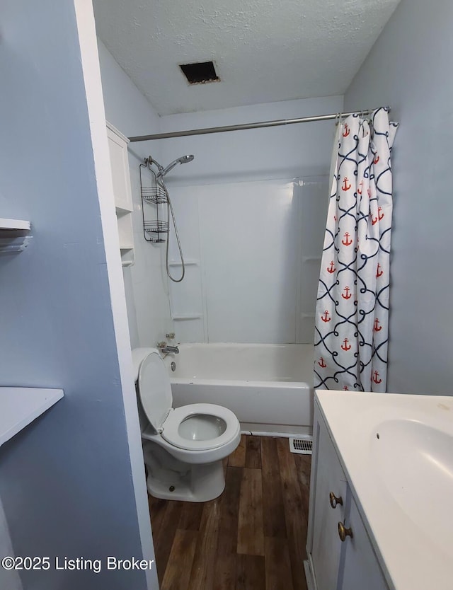 full bath featuring vanity, wood finished floors, shower / bath combo, and a textured ceiling