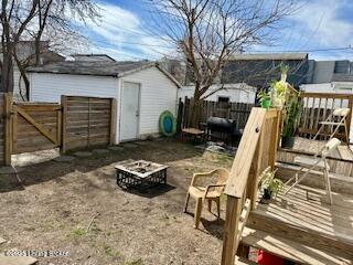 exterior space featuring a gate, an outdoor fire pit, and fence