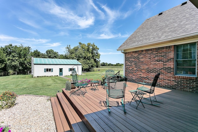 deck with a lawn and an outdoor structure