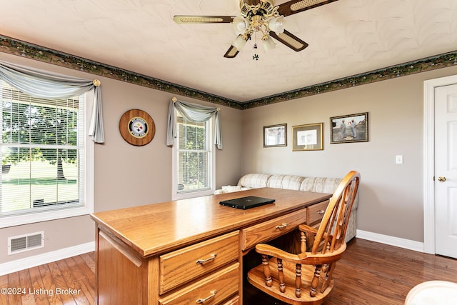 office space featuring a ceiling fan, wood finished floors, visible vents, and baseboards