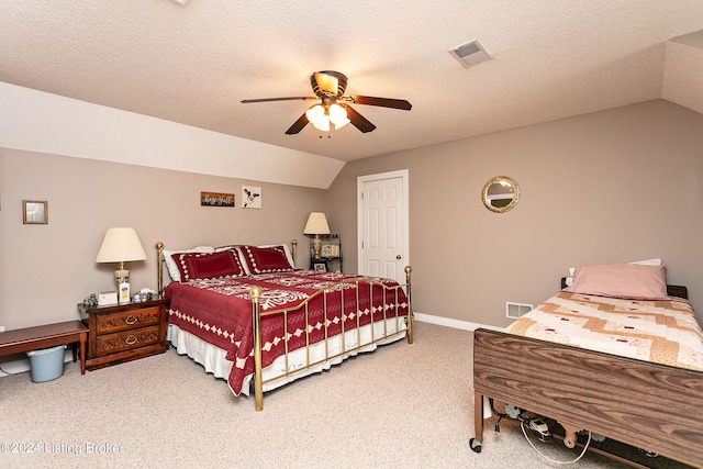 bedroom featuring lofted ceiling, light colored carpet, visible vents, a ceiling fan, and a textured ceiling