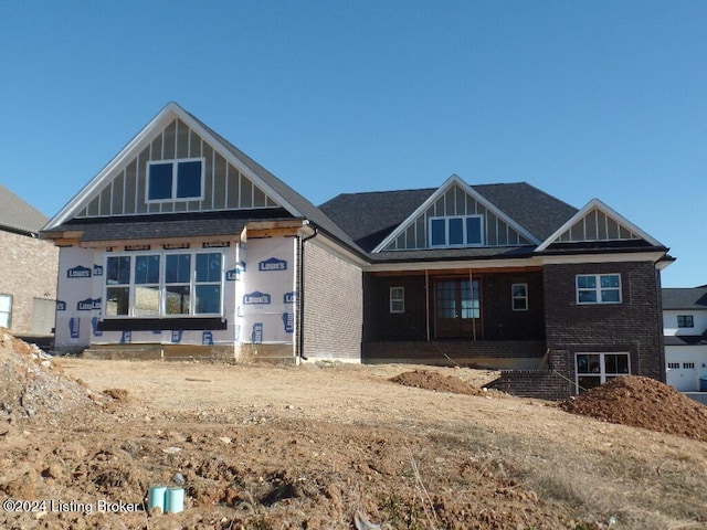 view of front of home with brick siding and board and batten siding