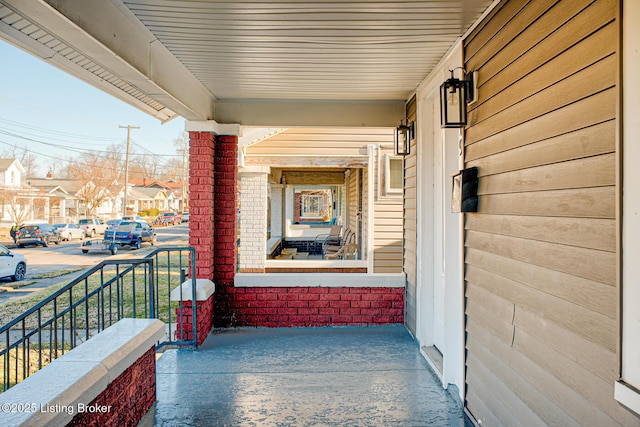 balcony featuring covered porch and a residential view