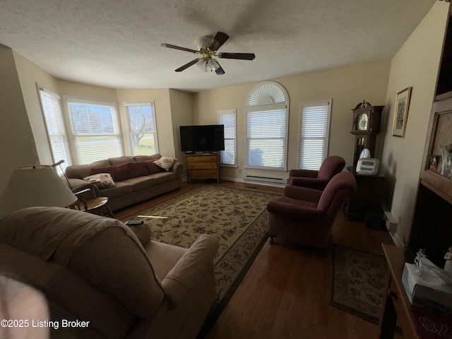 living area featuring ceiling fan, a textured ceiling, and wood finished floors