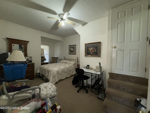 carpeted bedroom with a ceiling fan and a textured ceiling