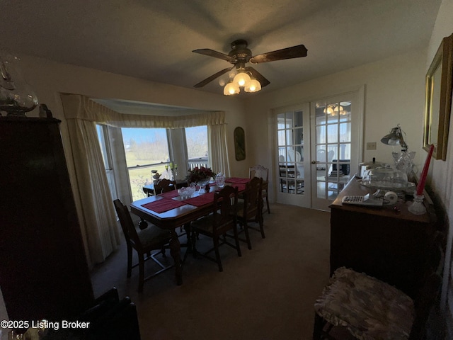 dining area with carpet, french doors, and ceiling fan