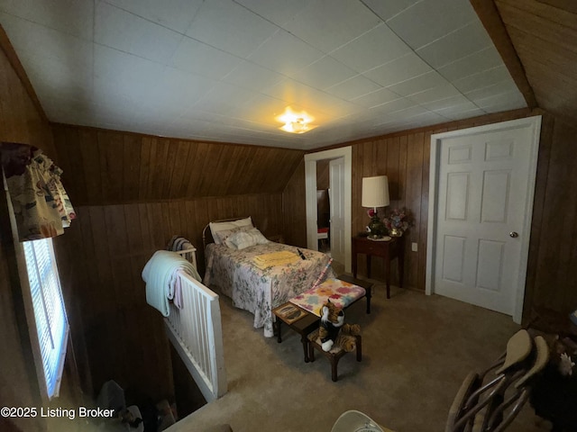 bedroom featuring vaulted ceiling, wood walls, and carpet flooring