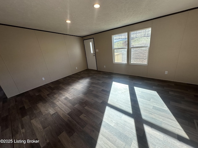 unfurnished room featuring dark wood-style floors and a textured ceiling