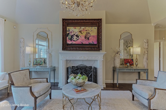 sitting room featuring wood finished floors, baseboards, and a premium fireplace