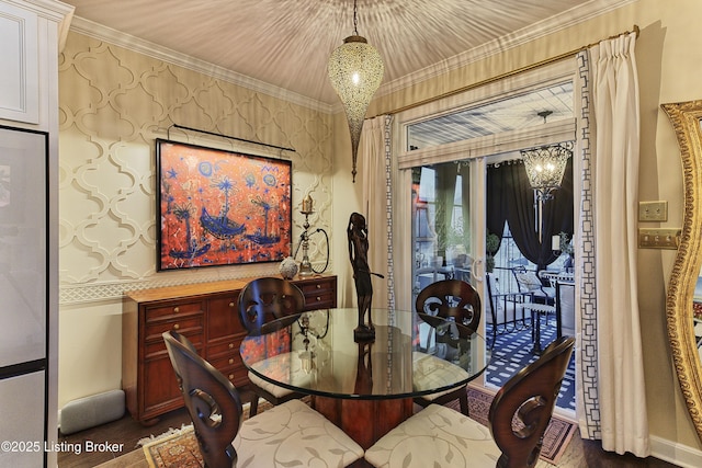 dining area with wallpapered walls, a chandelier, and ornamental molding