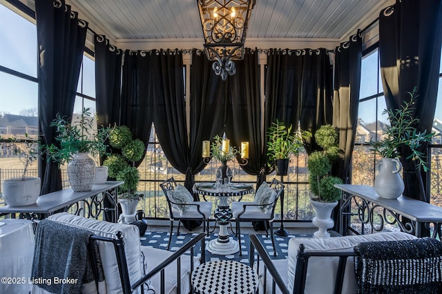 sunroom / solarium with a chandelier and wooden ceiling