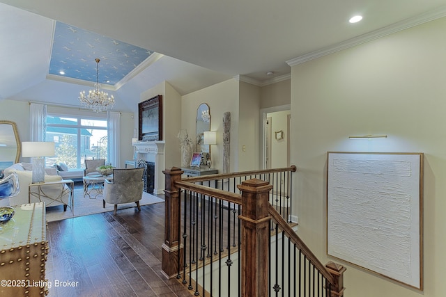 hallway with a chandelier, ornamental molding, an upstairs landing, hardwood / wood-style floors, and recessed lighting