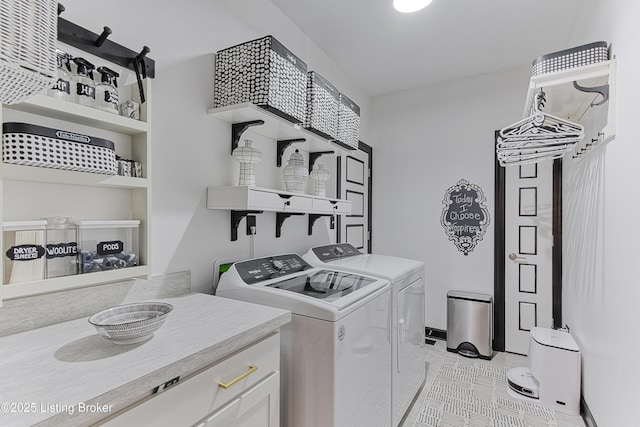 laundry area featuring washer and dryer, laundry area, and light tile patterned floors