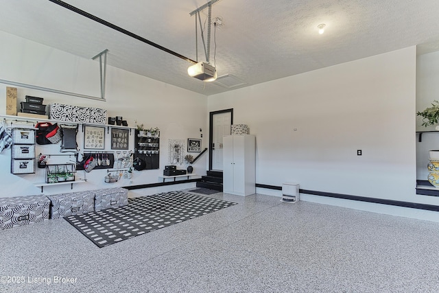 garage featuring a garage door opener and baseboards