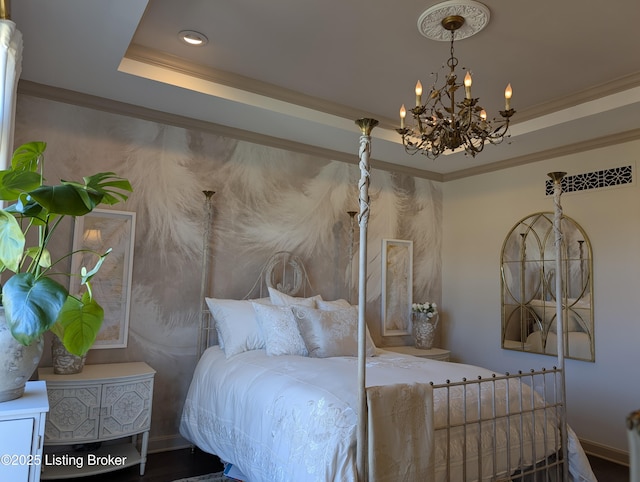 bedroom with a notable chandelier, crown molding, and a raised ceiling