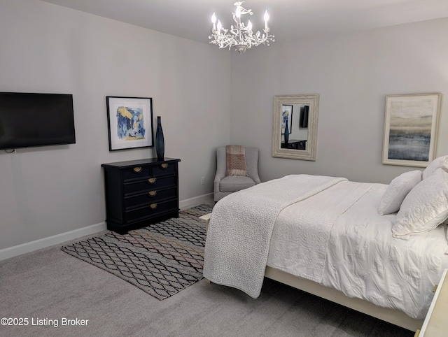 carpeted bedroom with baseboards and a chandelier