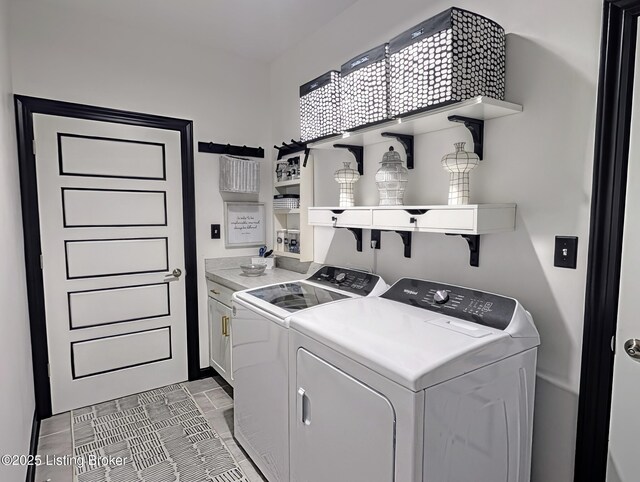 laundry room with cabinet space and washer and clothes dryer