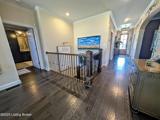 hallway with crown molding, baseboards, and hardwood / wood-style floors