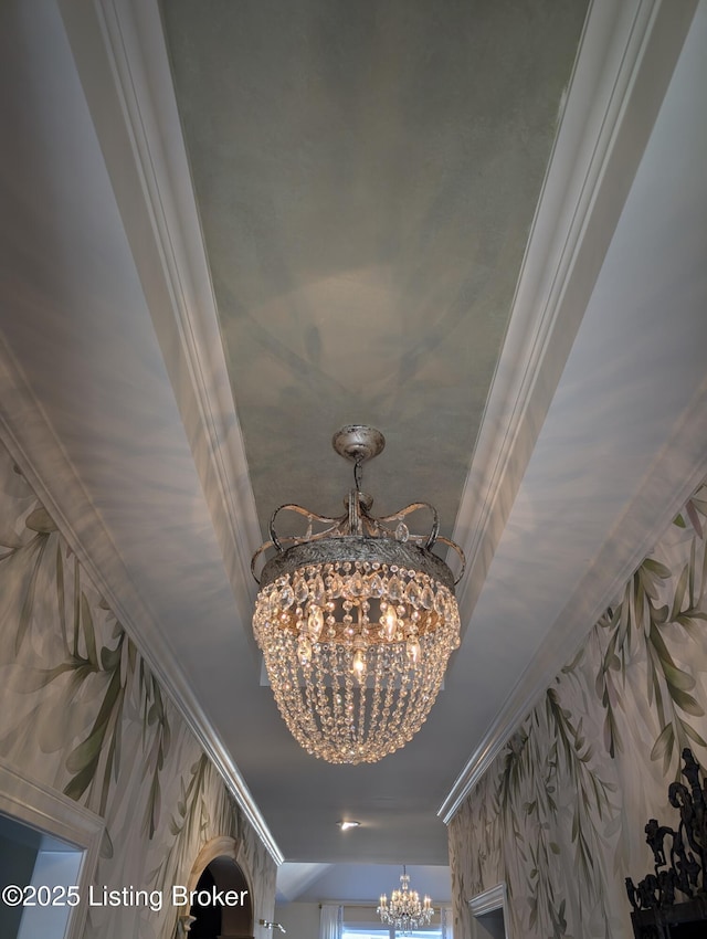 interior details with an inviting chandelier and ornamental molding