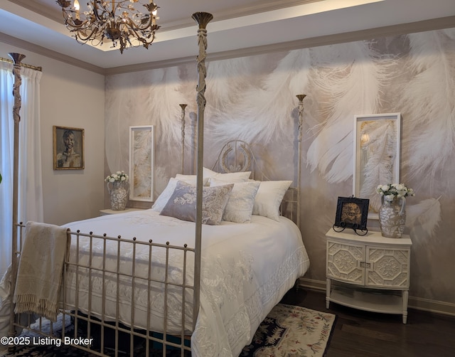 bedroom with a chandelier, ornamental molding, baseboards, and wood finished floors