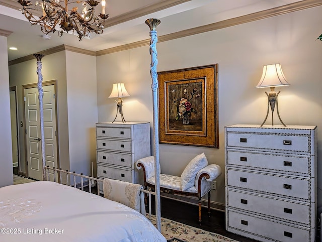 bedroom with baseboards, wood finished floors, and ornamental molding