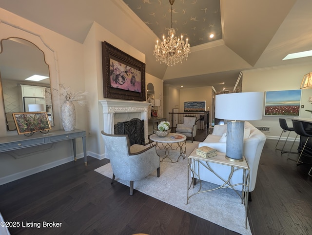 living room featuring a fireplace, baseboards, and wood finished floors