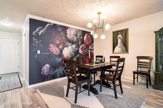 dining room with a textured ceiling, ornamental molding, a chandelier, and wood finished floors