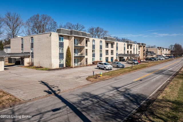 view of building exterior featuring uncovered parking