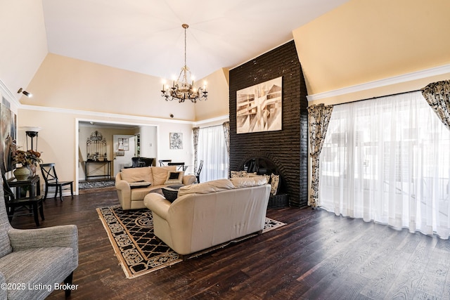 living area with high vaulted ceiling, plenty of natural light, an inviting chandelier, and wood finished floors