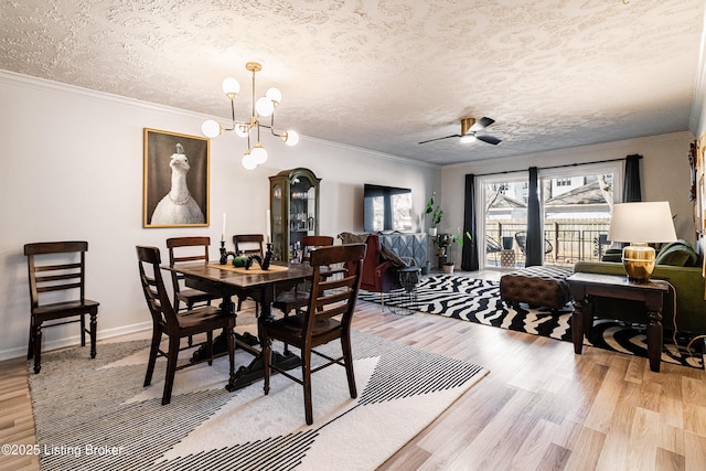 dining area with ornamental molding, light wood-style floors, a textured ceiling, baseboards, and ceiling fan with notable chandelier