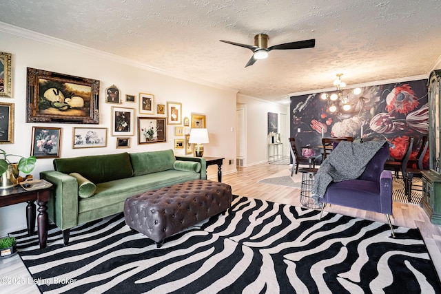 living area featuring a textured ceiling, an inviting chandelier, wood finished floors, and crown molding