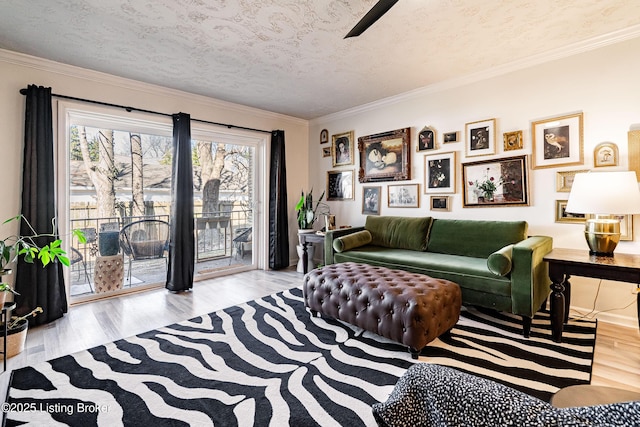 living area with a textured ceiling, wood finished floors, and crown molding