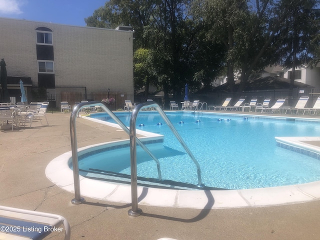 pool featuring a patio area and fence